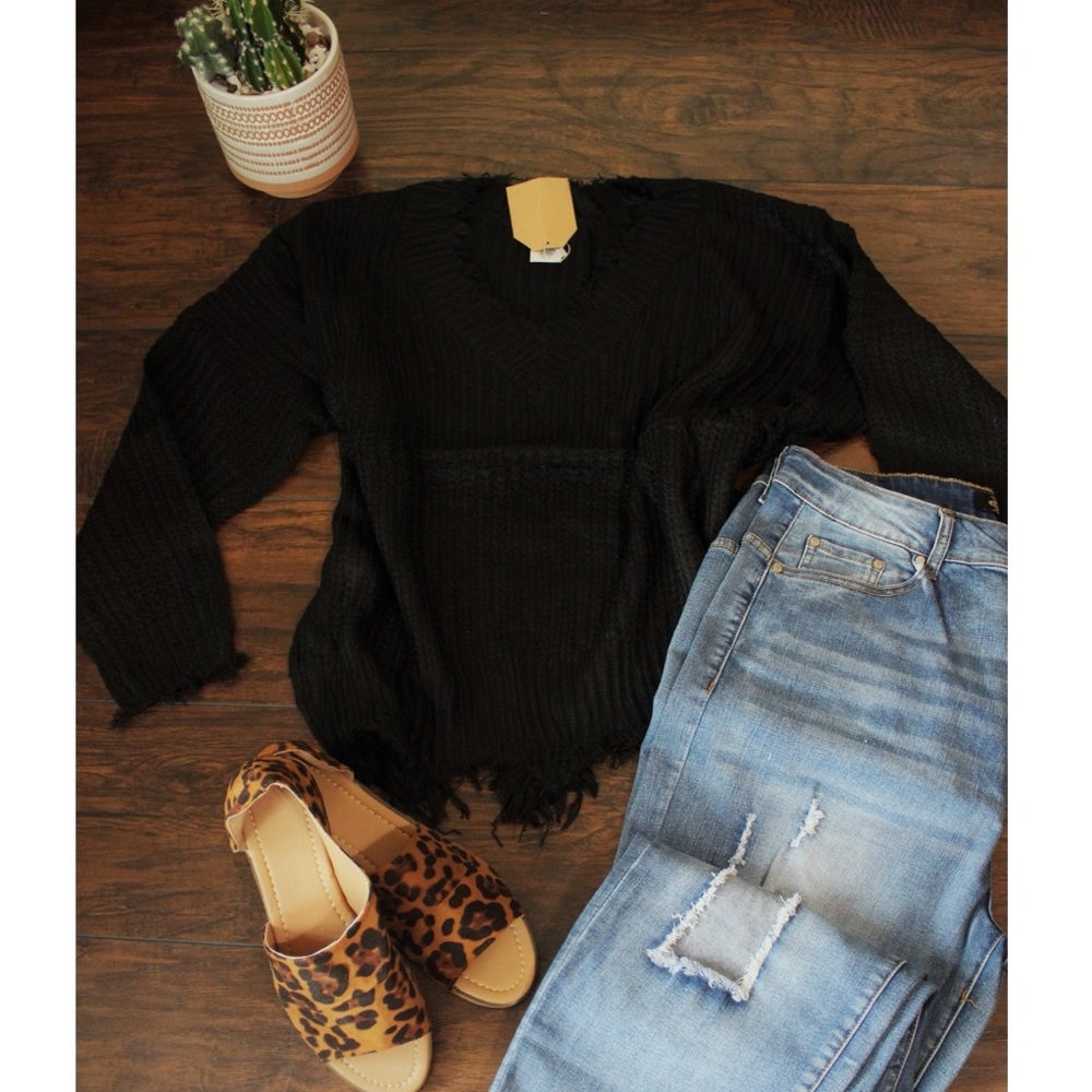 Distressed curvy fringe sweater.